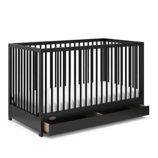 Black crib with open drawer angled