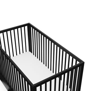 Close-up view of Black crib with drawer