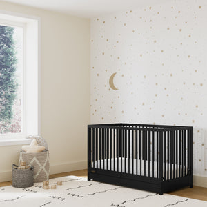 Black crib with drawer in nursery