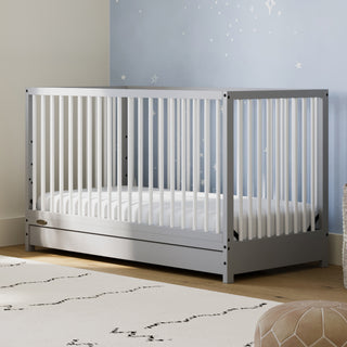 Pebble gray with white crib with drawer in nursery