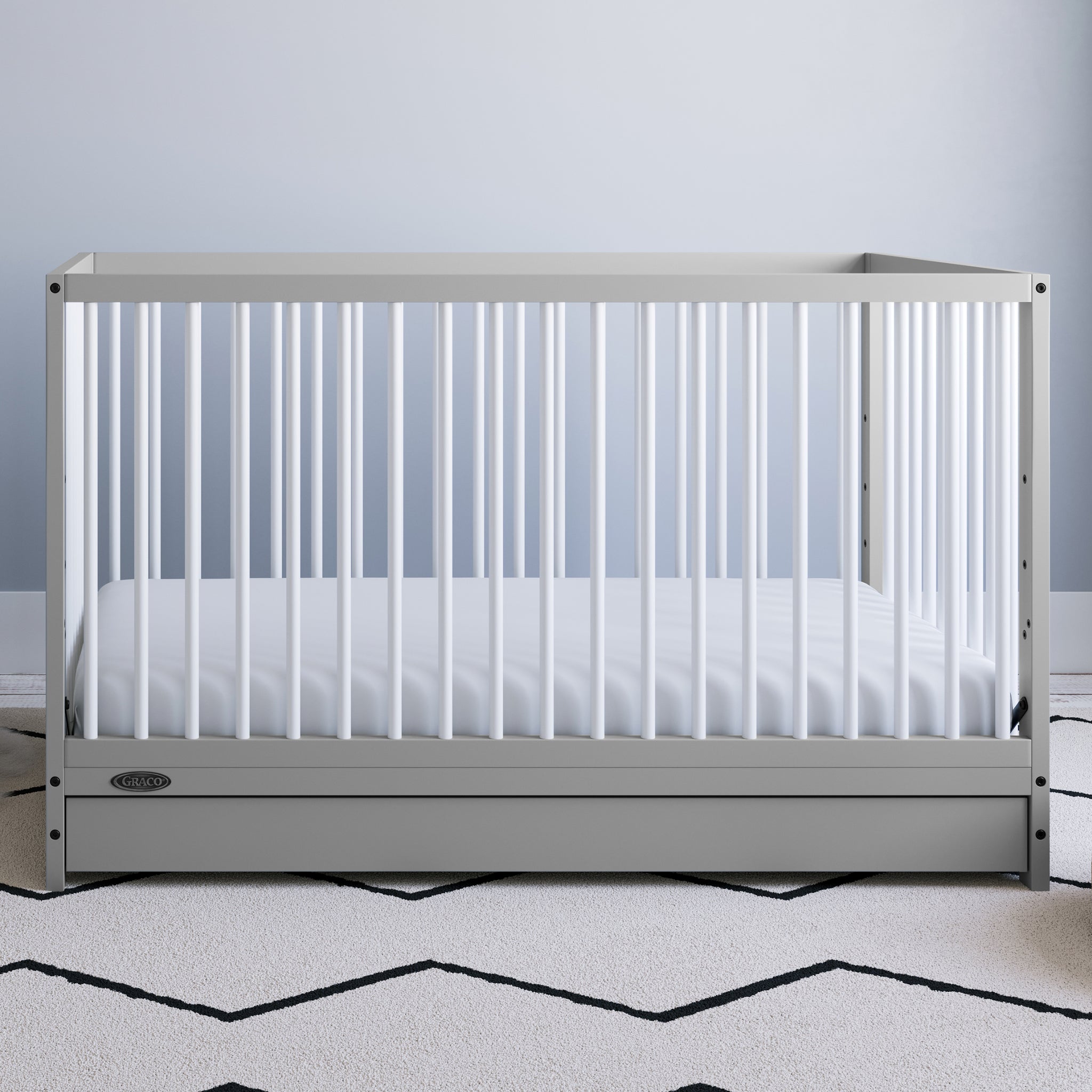Pebble gray with white crib with drawer in nursery