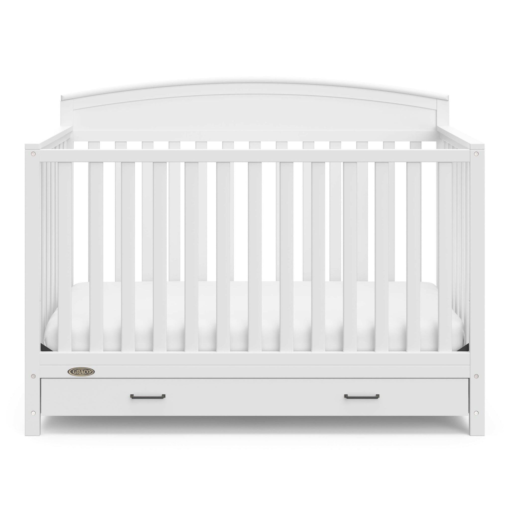 Front view of white crib with drawer