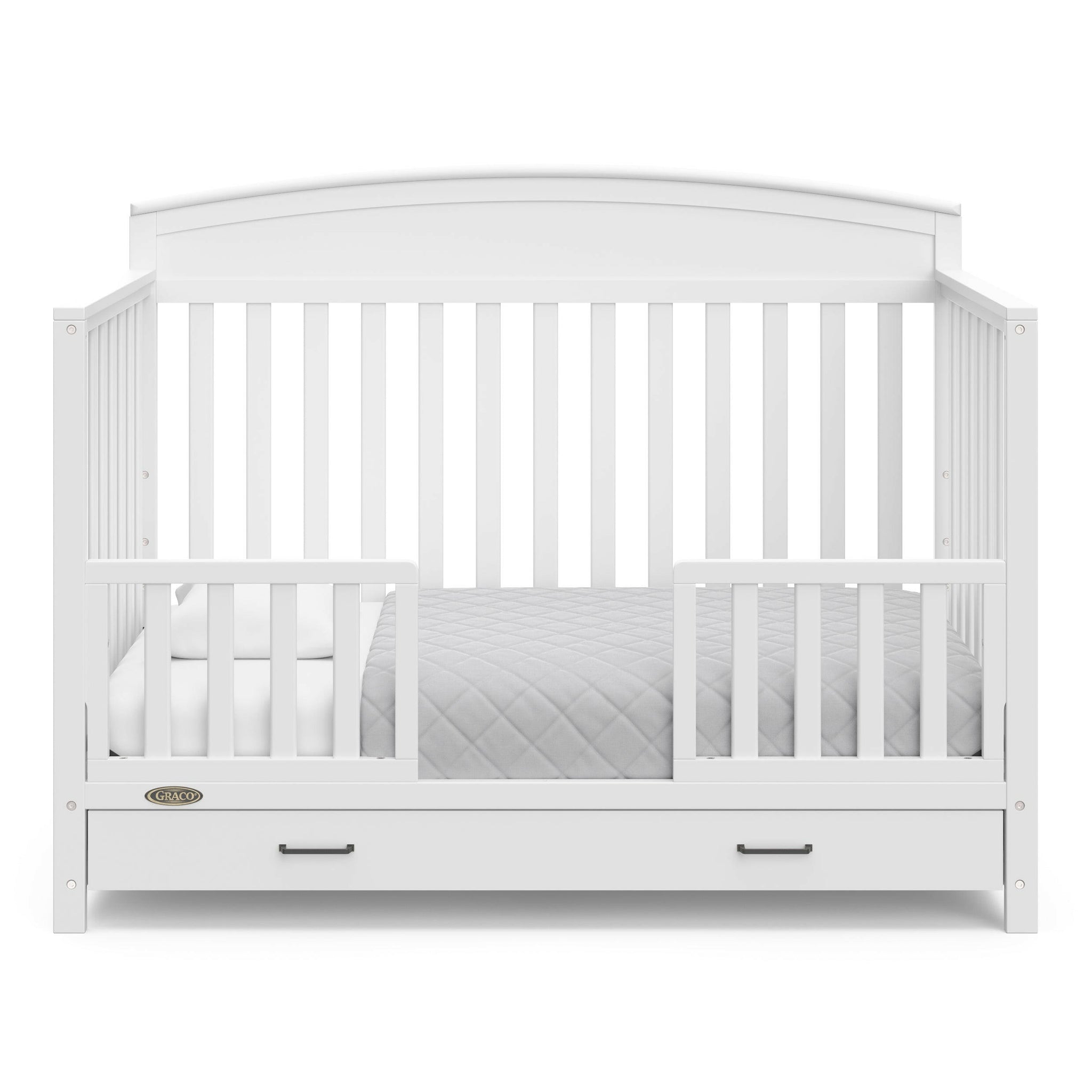 White crib with drawer in toddler bed conversion with two safety guardrails