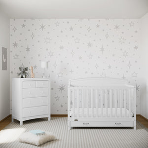 white crib with drawer in nursery