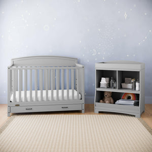 Pebble gray changing table with storage in nursery 