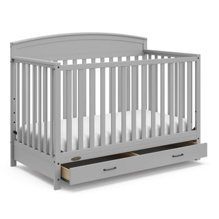 Pebble gray crib with open drawer angled