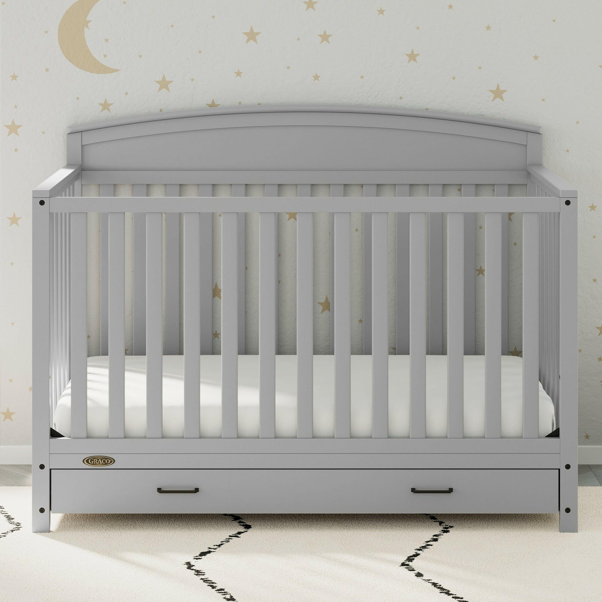 Pebble gray crib with drawer in nursery