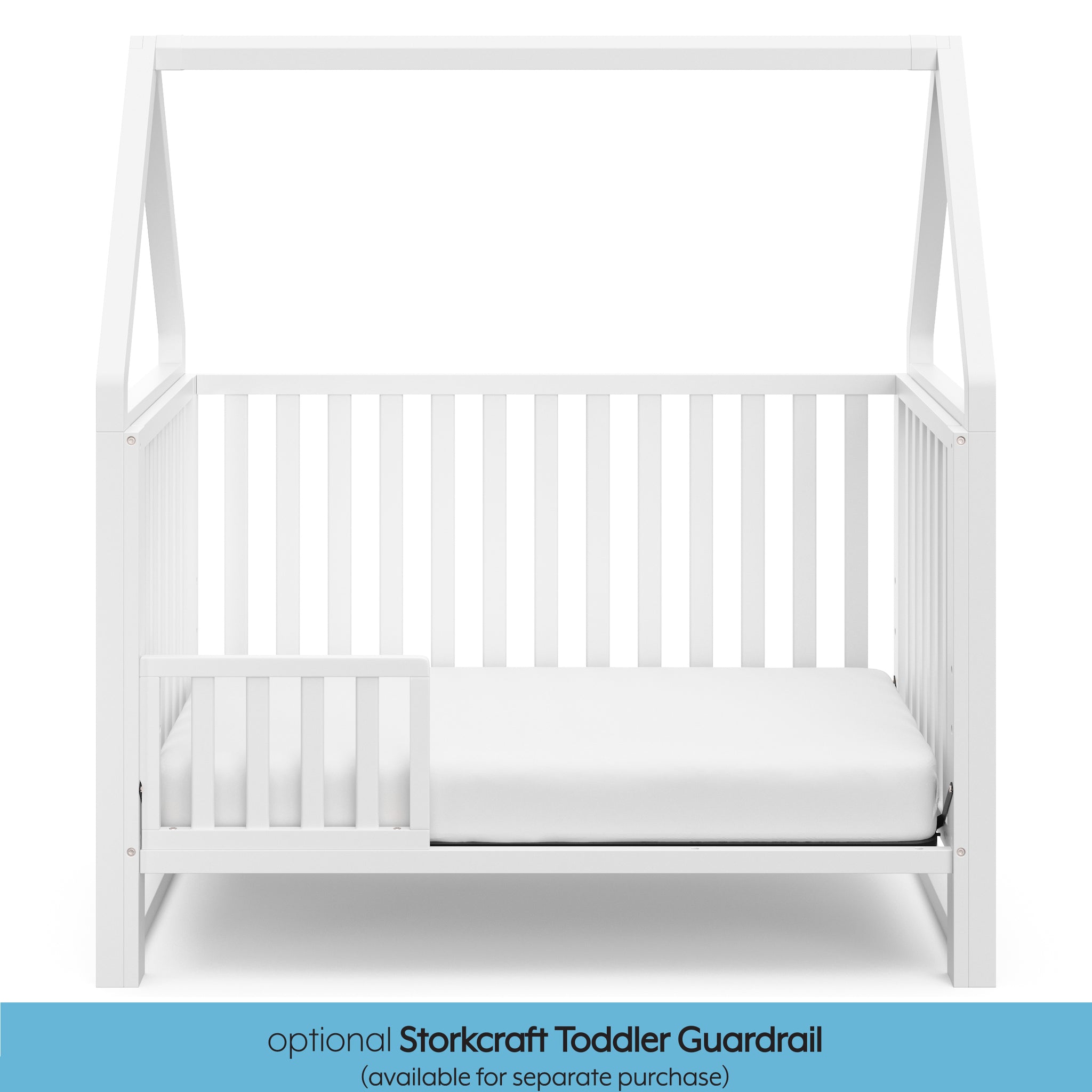 White crib in toddler bed conversion with one safety guardrail graphic 