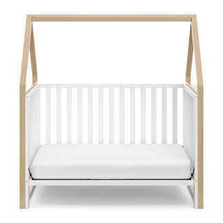 White crib with driftwood in toddler bed conversion 