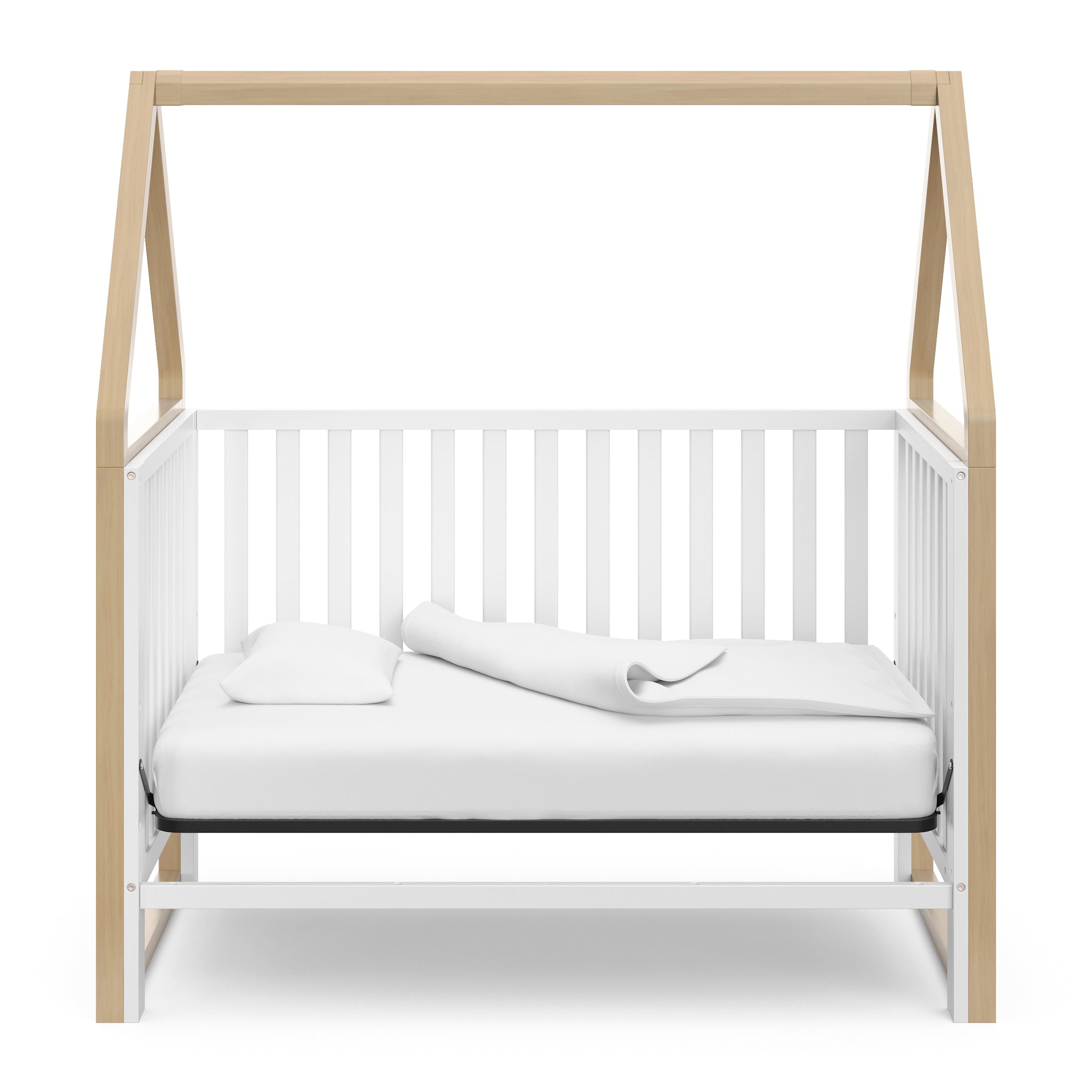 White crib with driftwood in day bed conversion 