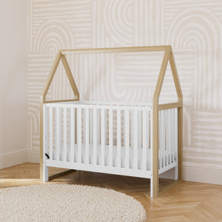 white with driftwood convertible canopy crib in nursery