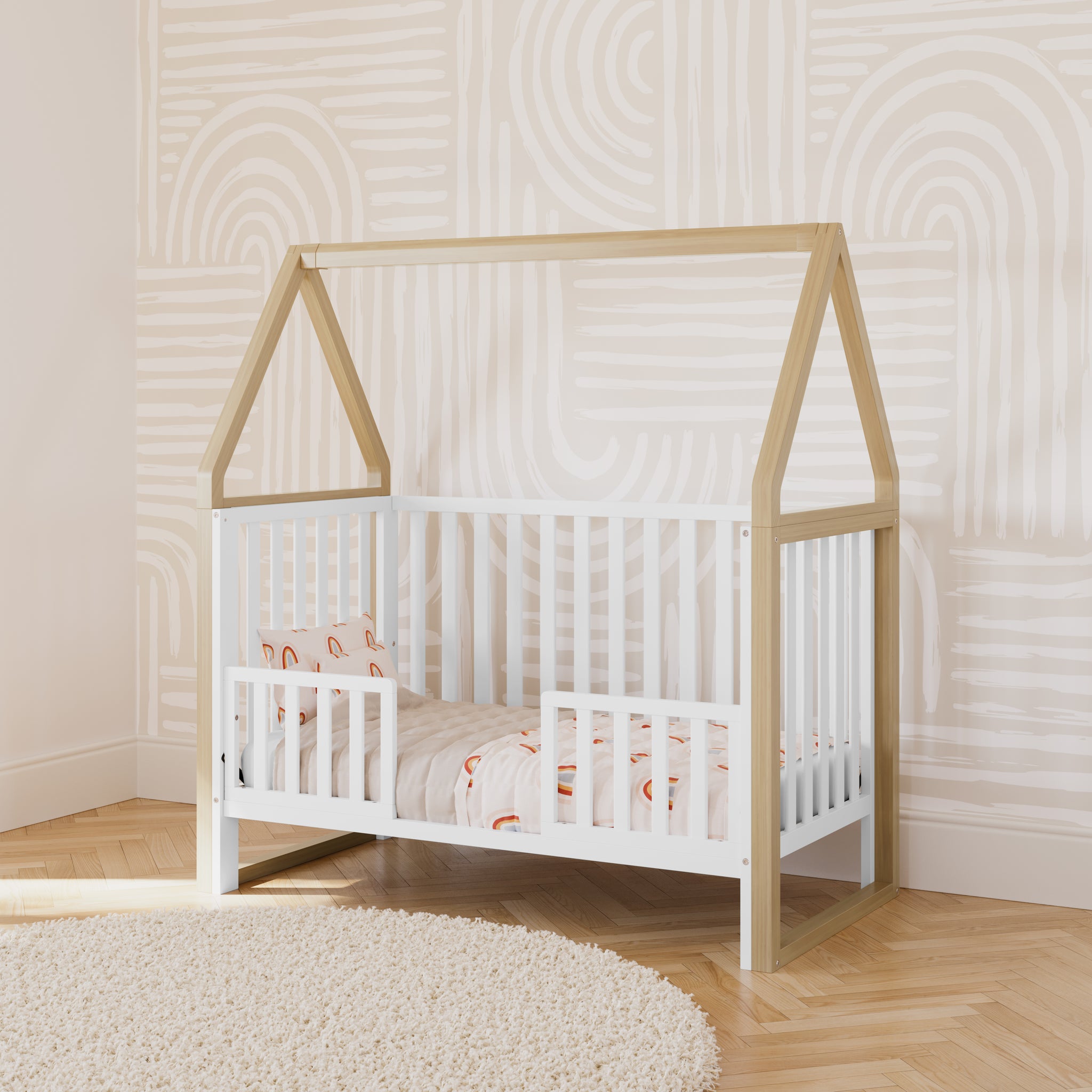 white with driftwood convertible canopy crib in toddler bed conversion with two toddler safety guardrails, in nursery
