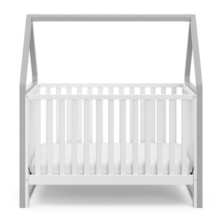 Front view of white crib with pebble gray 