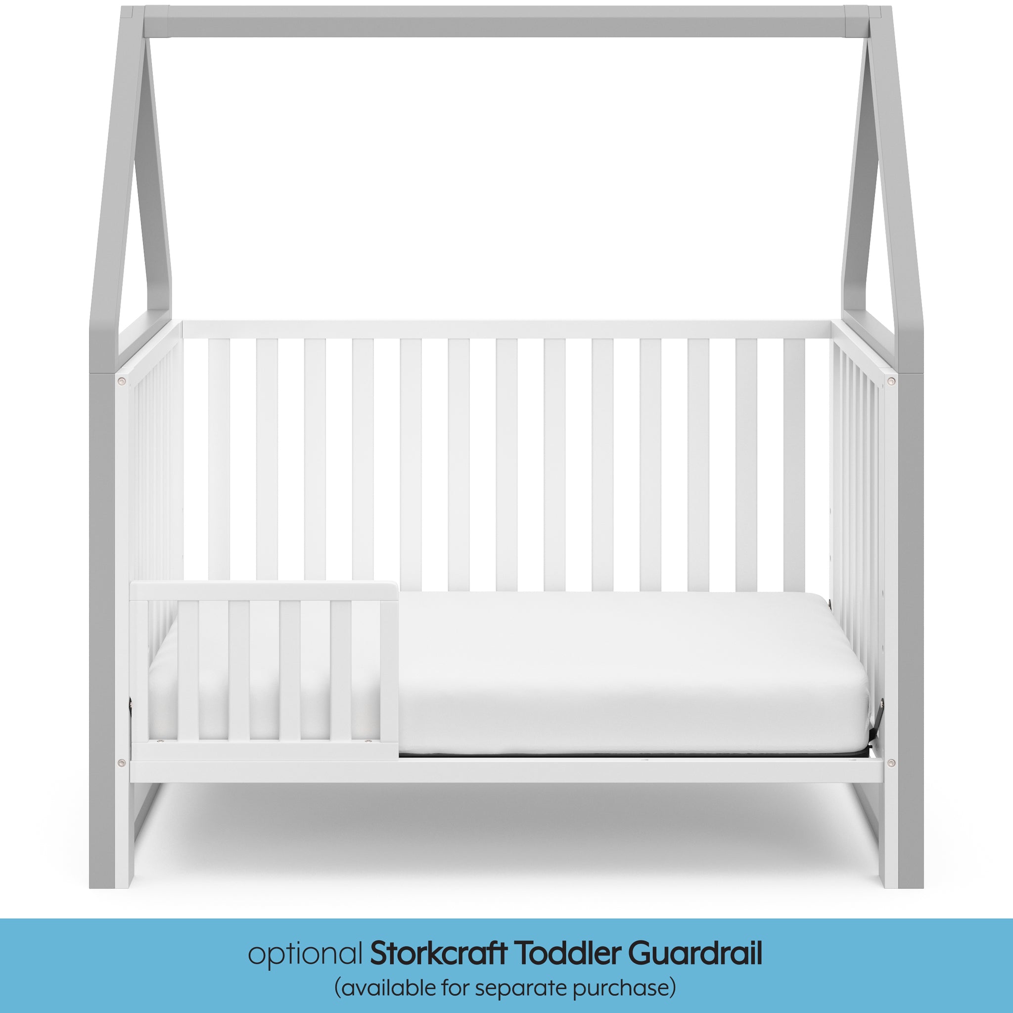 White crib with pebble gray in toddler bed conversion with one safety guardrail graphic