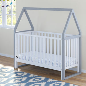 white crib with pebble gray in nursery