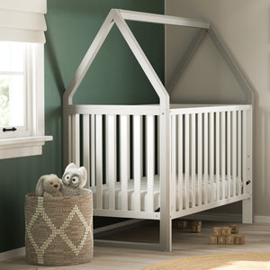 white crib with pebble gray in nursery