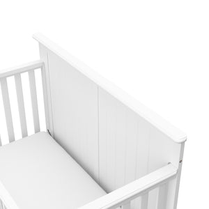 Close-up view of white crib headboard