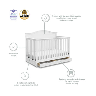 White crib with drawer features graphic