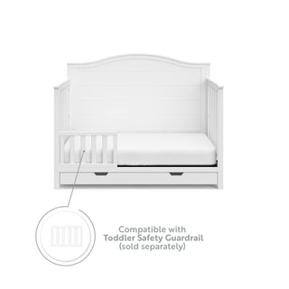 White crib with drawer in toddler bed conversion with one safety guardrail graphic