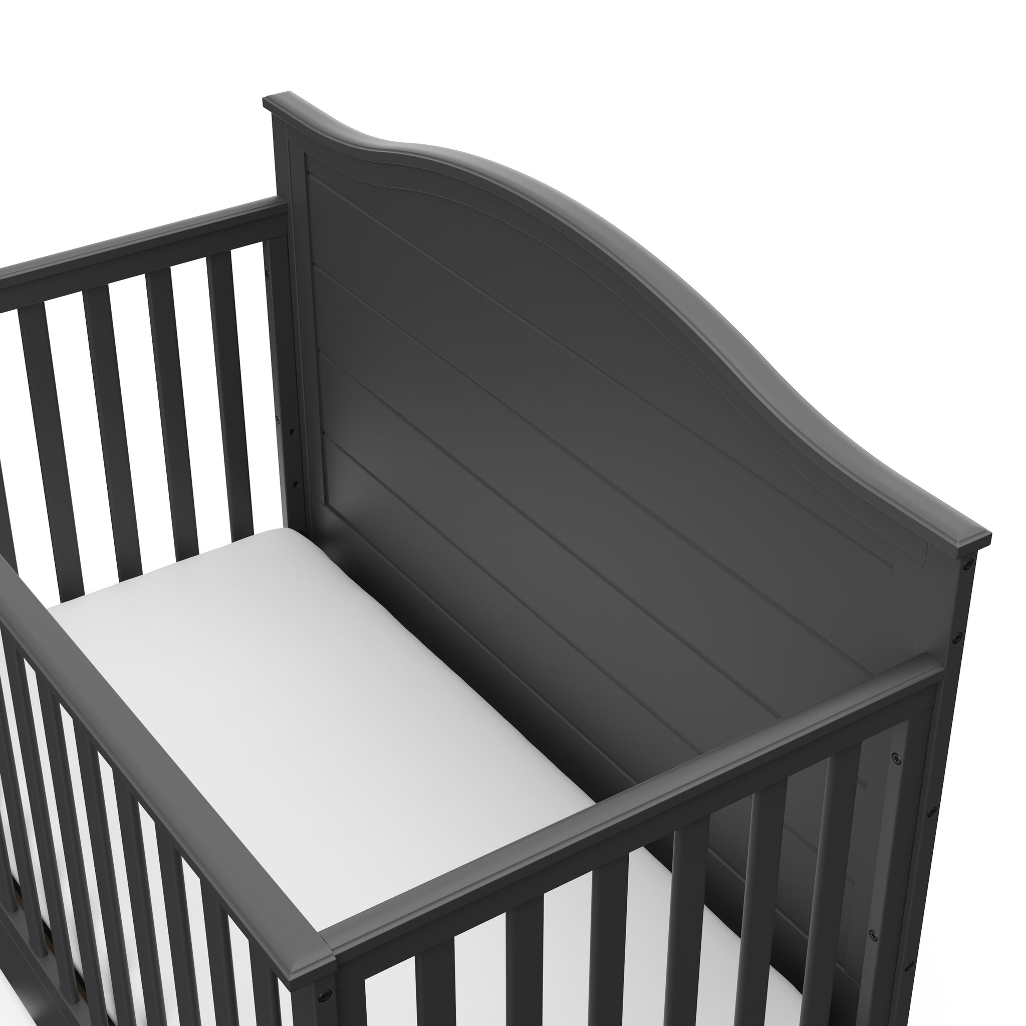 Close-up view of gray crib with drawer headboard
