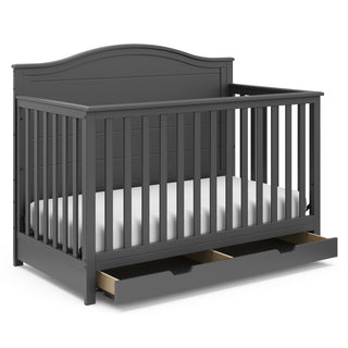 gray crib with open drawer angled
