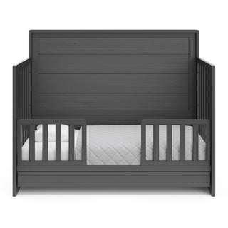 gray crib with drawer in toddler bed conversion with two safety guardrails