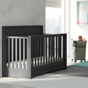 gray crib with drawer angled in nursery
