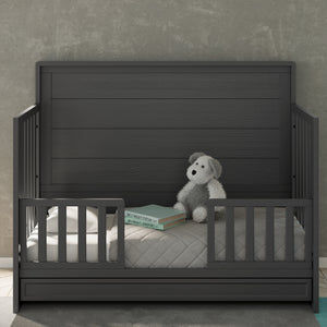 gray toddler safety guardrail applied in toddler bed, in nursery