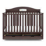 Front view of espresso crib with open drawer