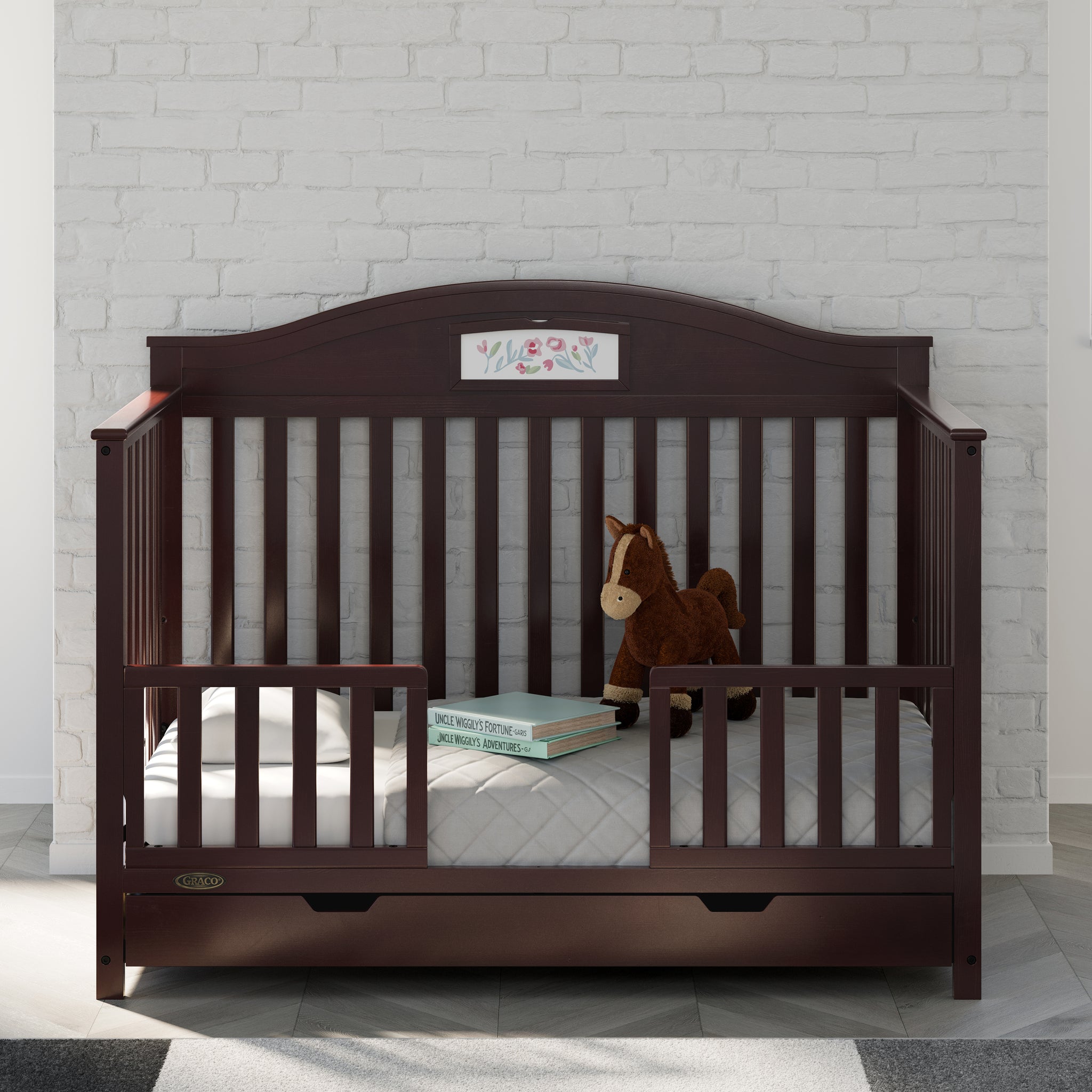 espresso toddler safety guardrail applied in toddler bed, in nursery