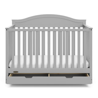 Front view of Pebble gray crib with open drawer