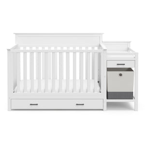 Front view of White crib and changer with drawer