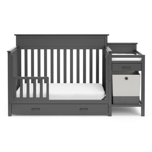 gray crib and changer with drawer in toddler bed conversion with one safety guardrail 