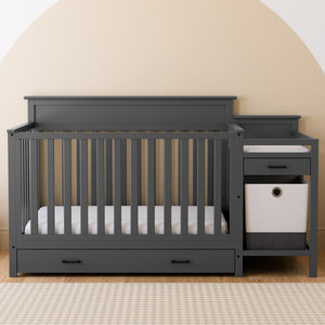 gray crib and changer with drawer in nursery
