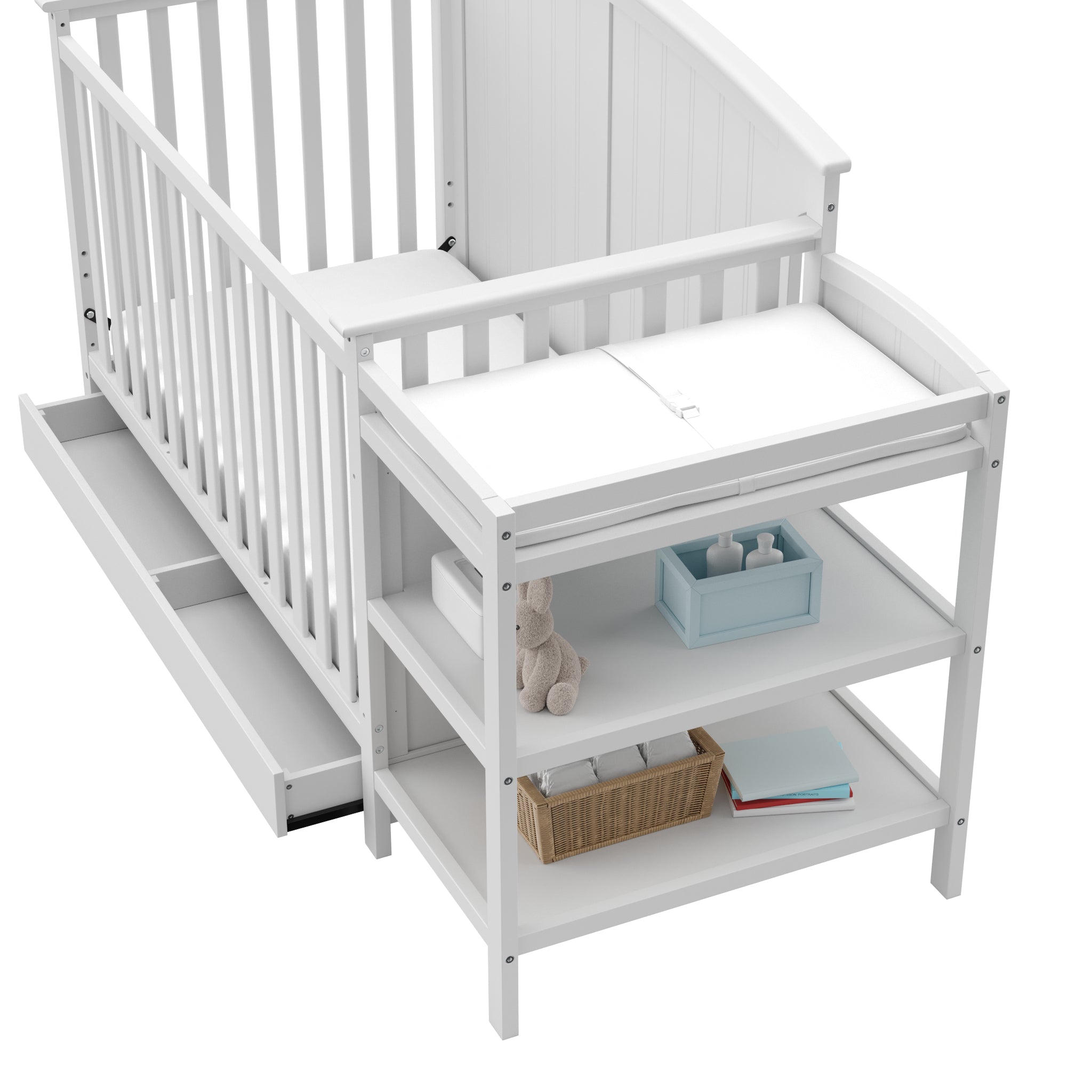 Close-up view of White crib and changer with open drawer 