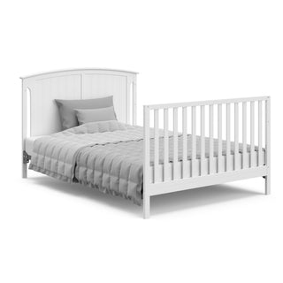 white crib in full-size bed conversion with headboard and footboard