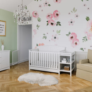 White crib and changer in nursery 