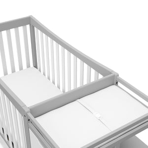 Close-up view of Pebble gray and white crib and changer