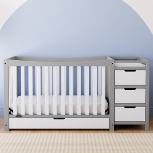 Pebble gray and white crib and changer with drawer in nursery