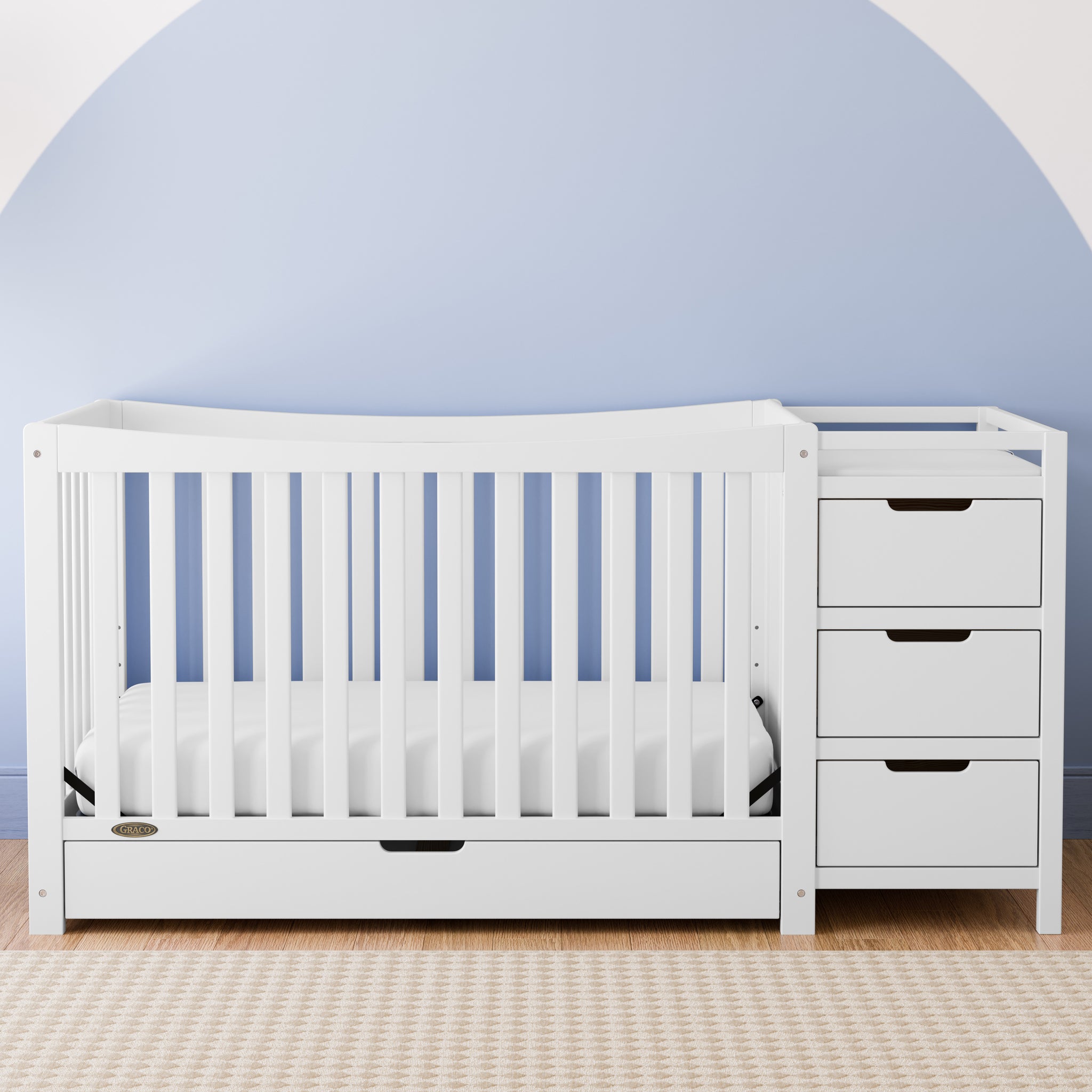 White crib and changer with drawer in nursery