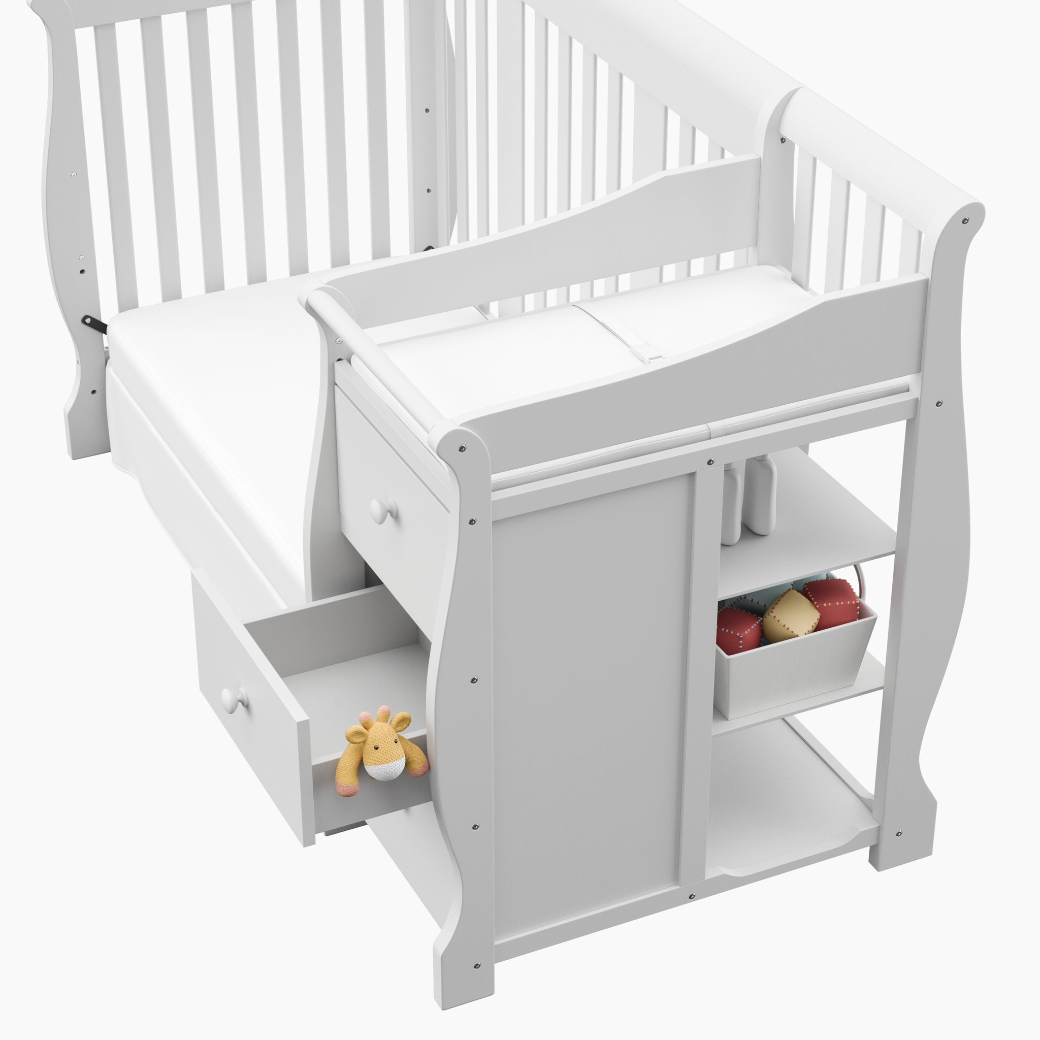 Close-up view of White crib and changer with open drawer 
