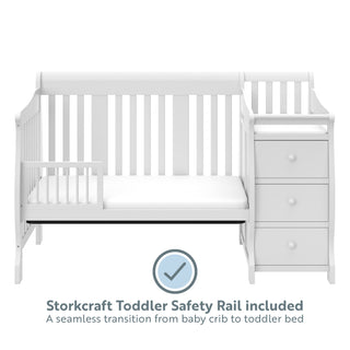 White crib in toddler bed conversion with one safety guardrail with graphic 