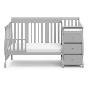 Pebble gray crib in toddler bed conversion with one safety guardrail 