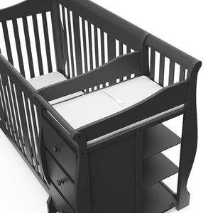 Close-up view of gray crib and changer 