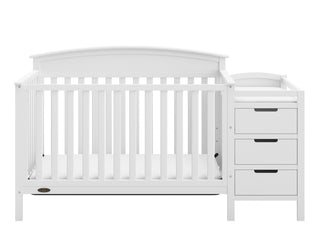 Front view of white crib and changer