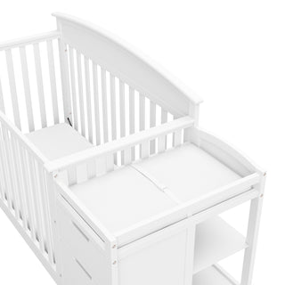 Close-up view of white crib and changer
