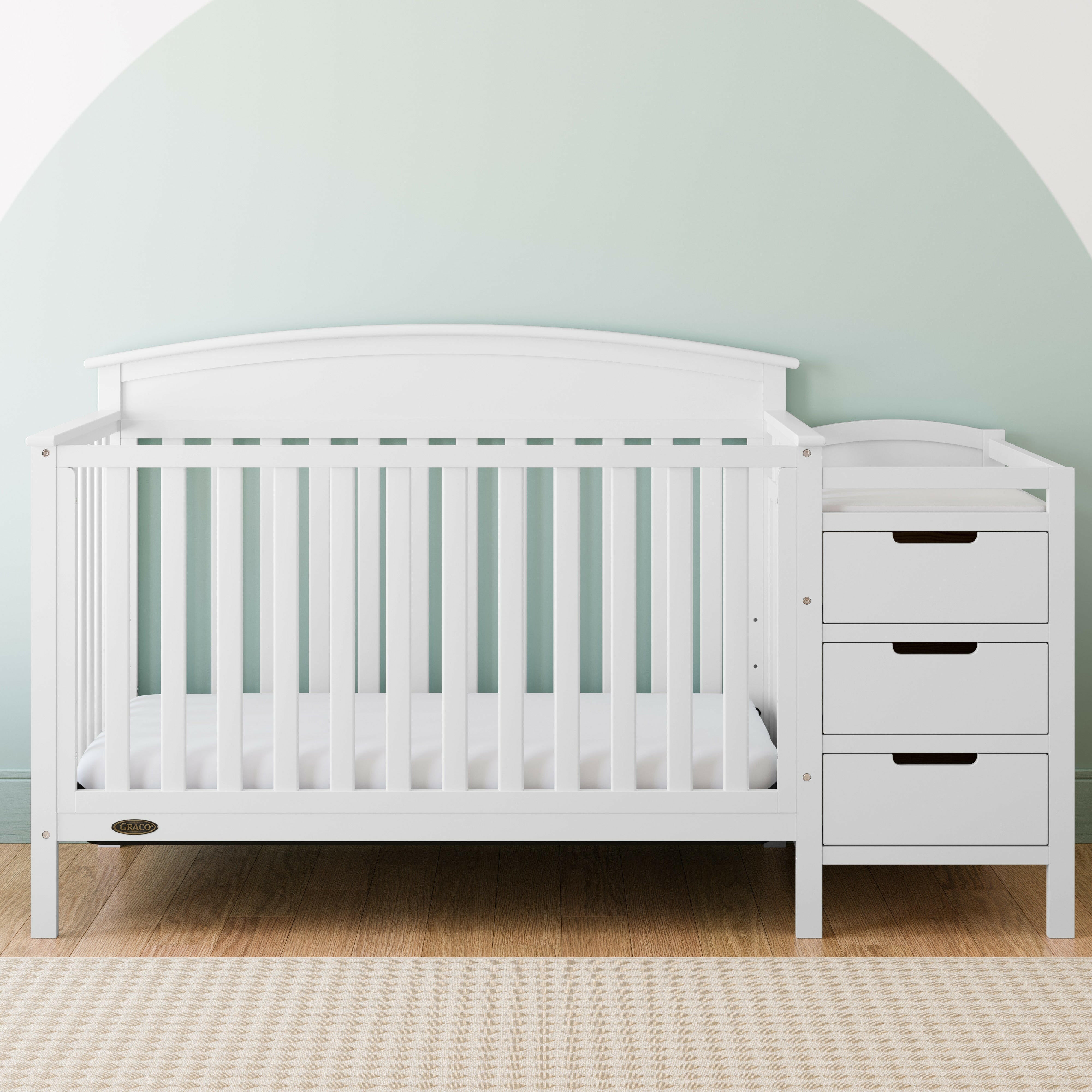 White crib and changer in nursery