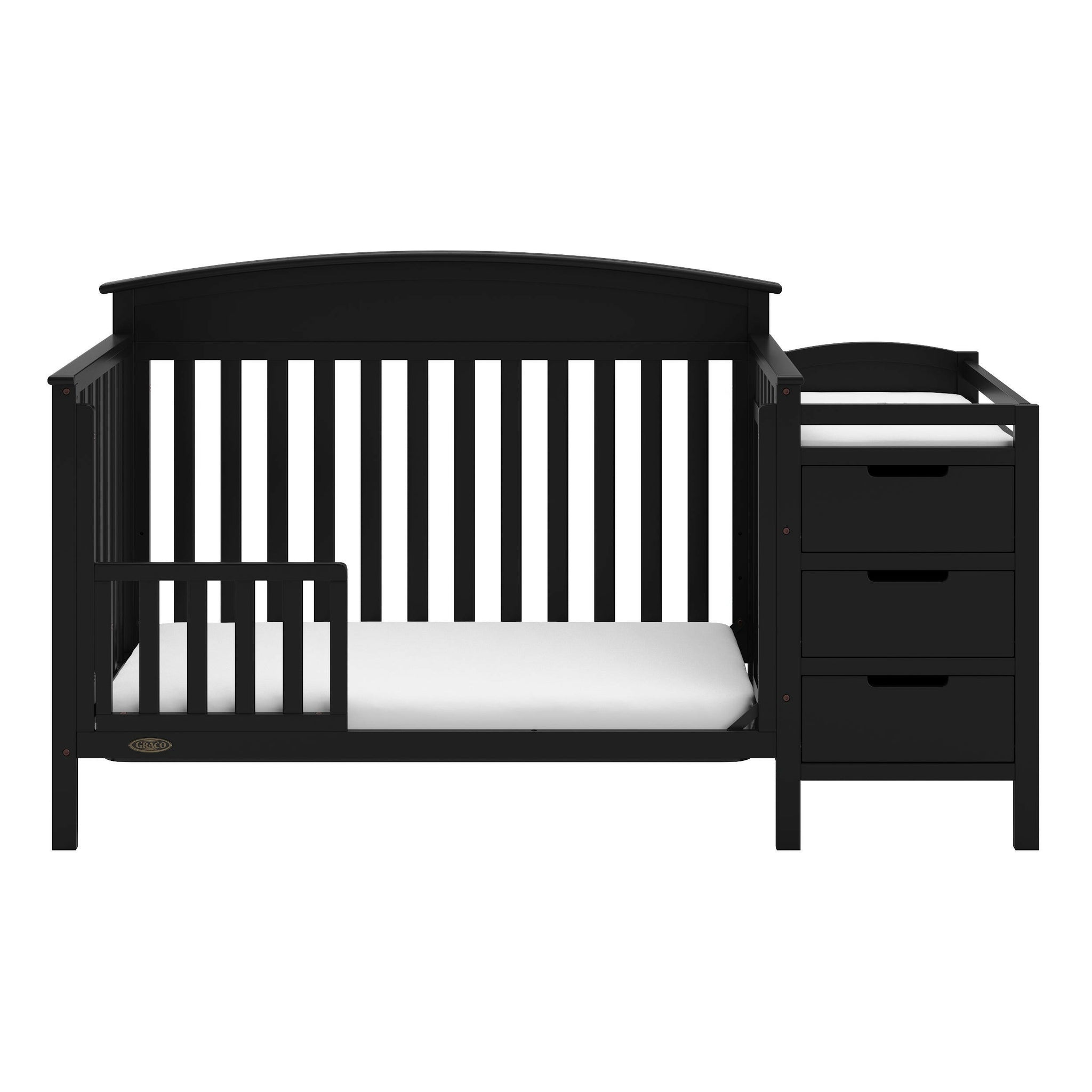 black crib in toddler bed conversion with one safety guardrail