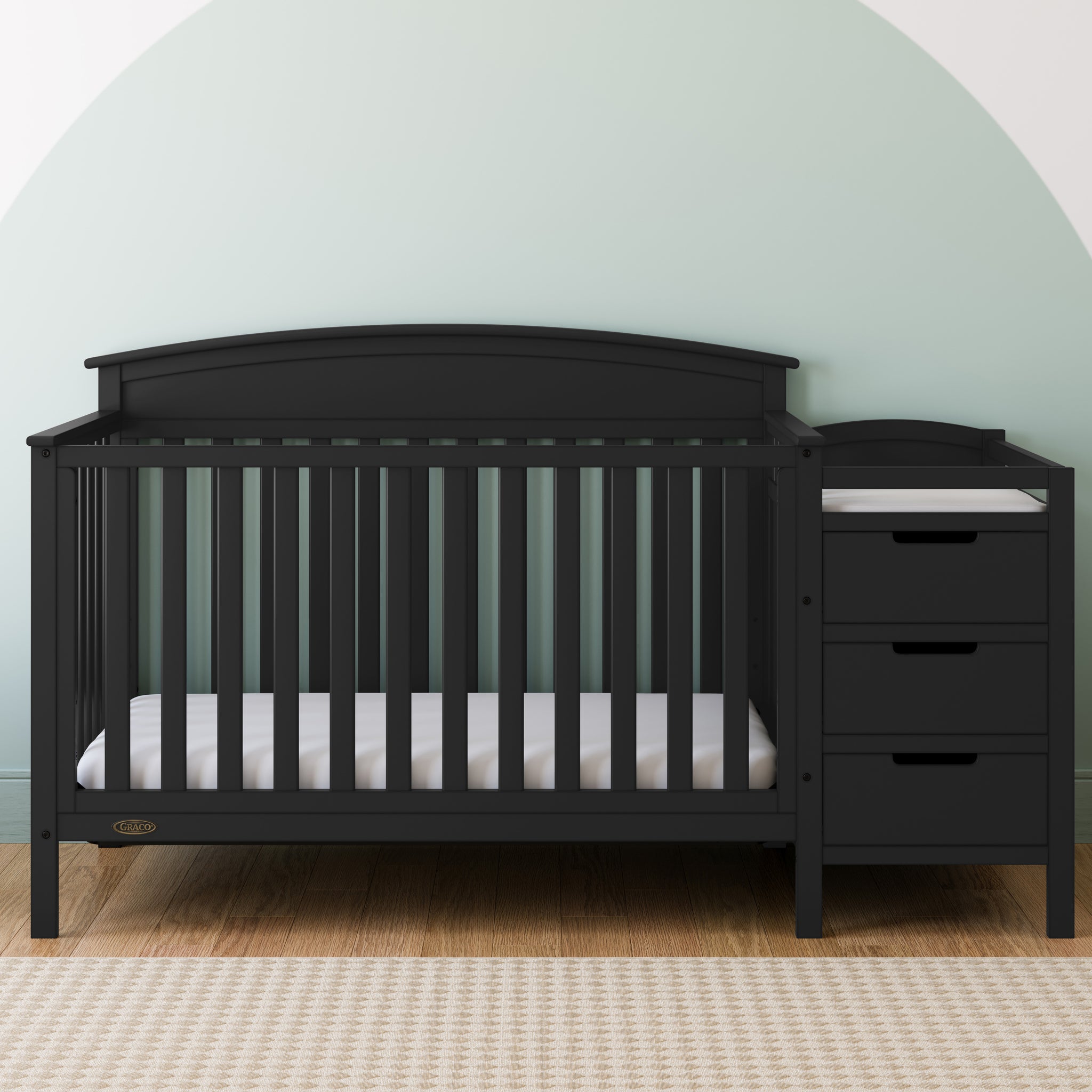 black crib and changer in nursery