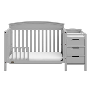 Pebble gray crib in toddler bed conversion with one safety guardrail